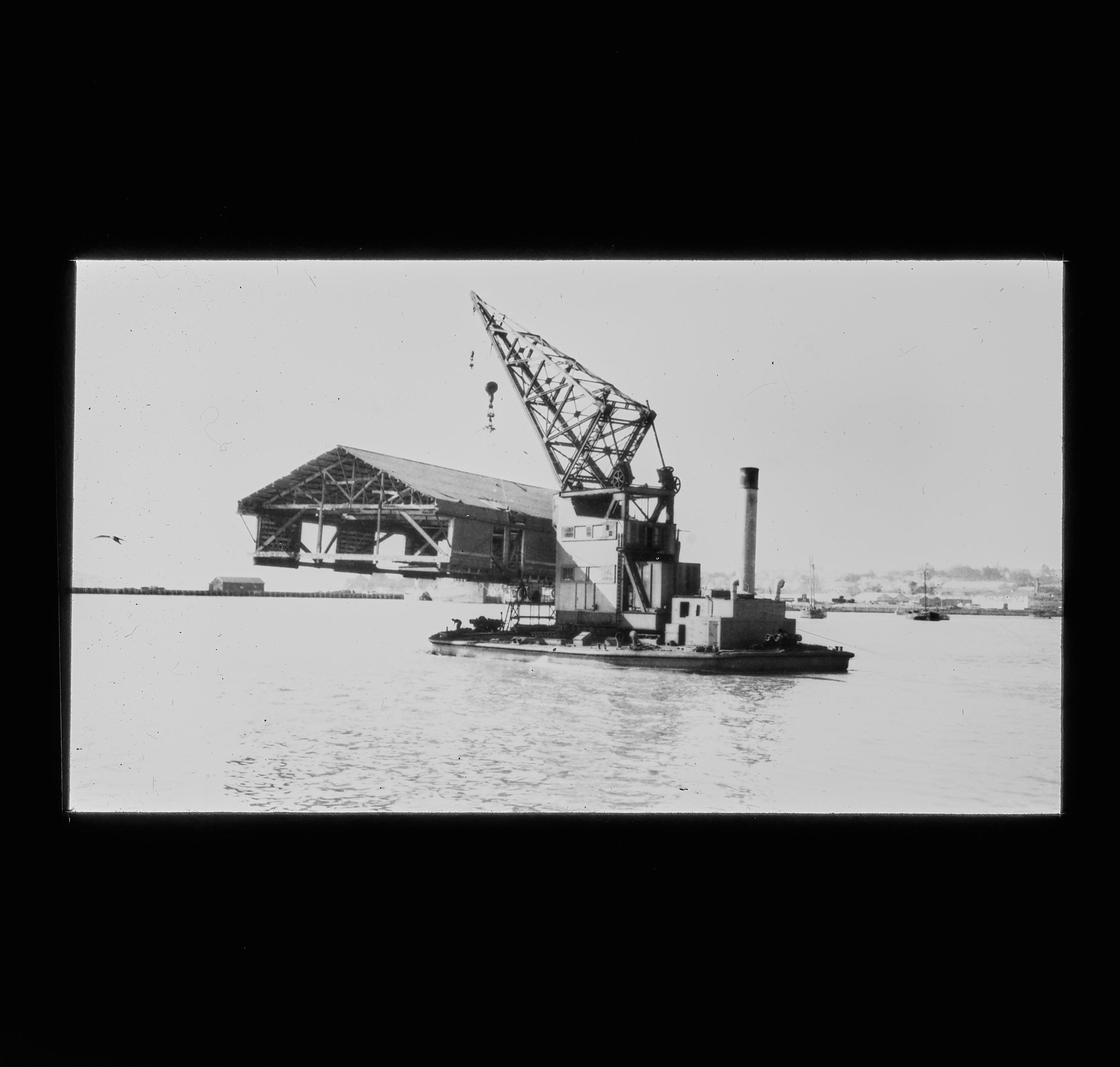 Lantern slide Boat shed being winched by a floating crane MAHUA (1912