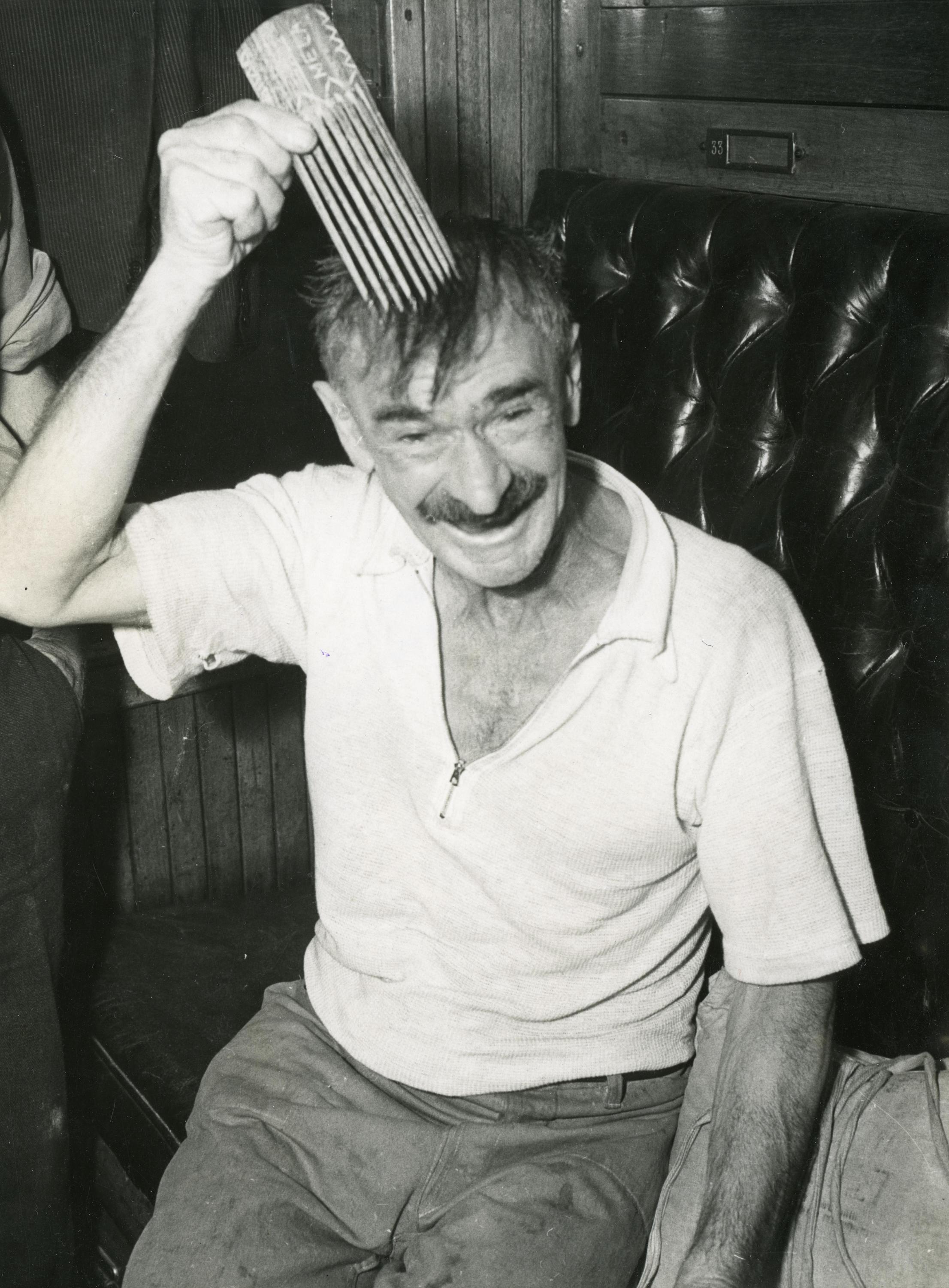 Photograph: Crew member from RANGITANE with a comb, Brisbane, 1941 ...
